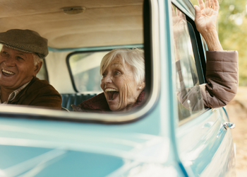 senior couple laughing in car