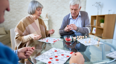 elderly couple playing checkers